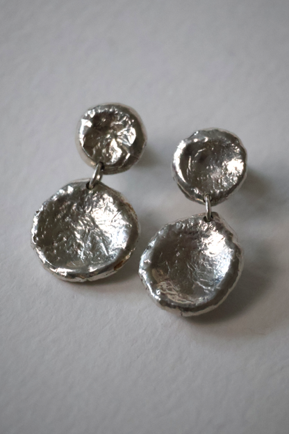Pair of silver earrings on a white background